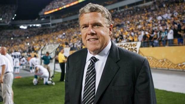 Peter King walks on a field